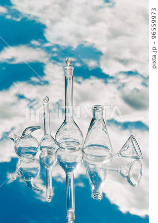 Various laboratory glassware on a mirror background with sky reflection 96559973