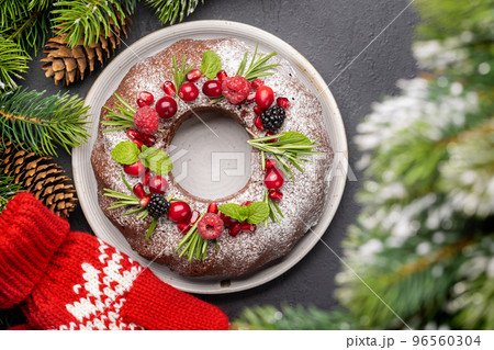 Christmas cake with pomegranate seeds, cranberries and rosemary Christmas cake with pomegranate seeds, cranberries and rosemary 96560304