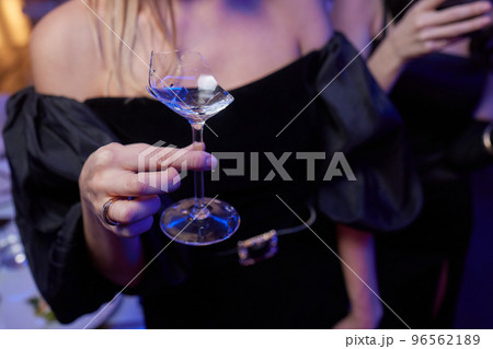 broken glass of champagne in hand Clinking glasses with alcohol and toasting, party. broken glass of champagne in hand Clinking glasses with alcohol and toasting, party. 96562189