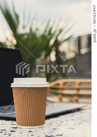 Mock up of modern laptop at table in beach resort. Remote Freelancer's place of work. Study and work online. Remote business education. Concept of webinar. E-learning Workstation Take away recycling 96562947