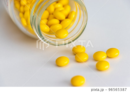 ガラス瓶と黄色の錠剤 96565387