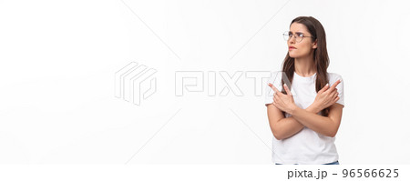 Waist-up portrait of troubled, thoughtful and indecisive young 20s woman in glasses, frowning skeptical and hesitant, cross hands pointing left and right, two variants both good, thinking what choose Waist-up portrait of troubled, thoughtful and indecisive young 20s woman in glasses, frowning skeptical and hesitant, cross hands pointing left and right, two variants both good, thinking what choose 96566625