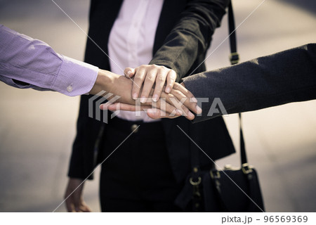 Professional young business people handsake, united, joining , combine hands together expressing positive, unity, volunteer , teamwork concepts.. Professional young business people handsake, united, joining , combine hands together expressing positive, unity, volunteer , teamwork concepts.. 96569369