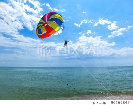 Couple flying high from glider parachut 96569847