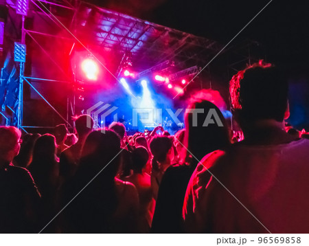 Crowd raising their hands and enjoying great festival party or concert. Crowd raising their hands and enjoying great festival party or concert. 96569858