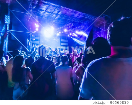 Crowd raising their hands and enjoying great festival party or concert. Crowd raising their hands and enjoying great festival party or concert. 96569859
