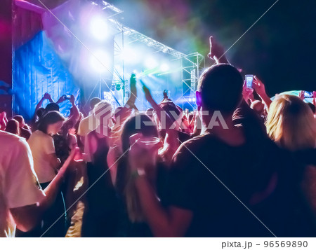 Crowd raising their hands and enjoying great festival party or concert. 96569890