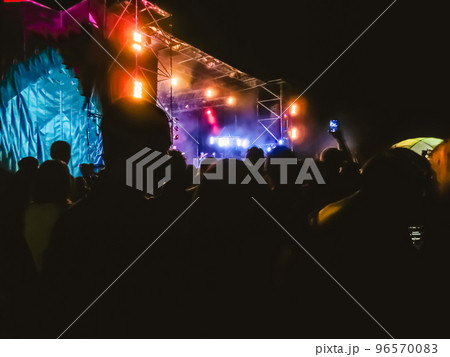 Crowd raising their hands and enjoying great festival party or concert. Crowd raising their hands and enjoying great festival party or concert. 96570083