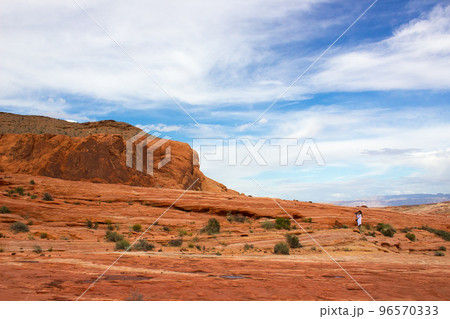 Female tourist taking photos in mountains Female tourist taking photos in mountains 96570333