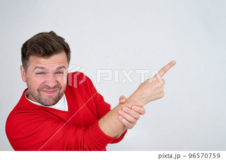 Serious man pointing finger up showing logo promo aside, pay attention here Serious man pointing finger up showing logo promo aside, pay attention here 96570759