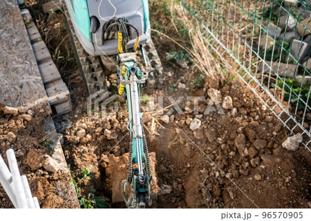 Mini excavator digs a trench to lay pipes. Close up of an excavator digging a deep trench. An excavator digs a trench in the countryside to lay a water pipe. Slow motion Mini excavator digs a trench to lay pipes. Close up of an excavator digging a deep trench. An excavator digs a trench in the countryside to lay a water pipe. Slow motion 96570905