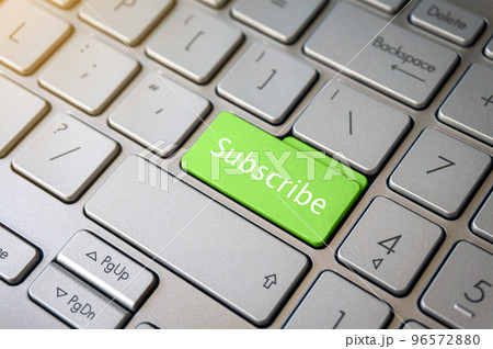 Green Subscribe button on laptop keyboard close-up. Green Subscribe button on laptop keyboard close-up. 96572880