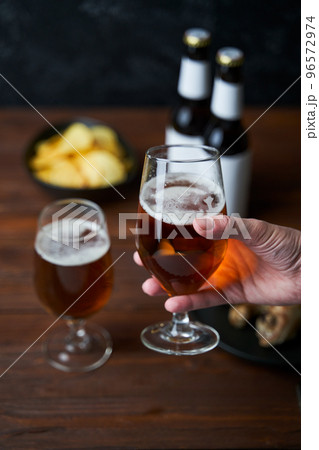 Two glasses with beer, snacks and bottles Two glasses with beer, snacks and bottles 96572974
