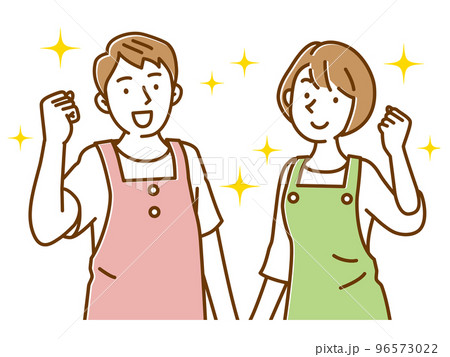 エプロン姿でガッツポーズする若い男女 96573022