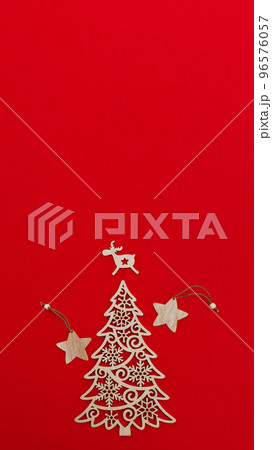 wooden decorative decoration of fir-tree, star and deer on red background, vertical, 16:9 wooden decorative decoration of fir-tree, star and deer on red background, vertical, 16:9 96576057