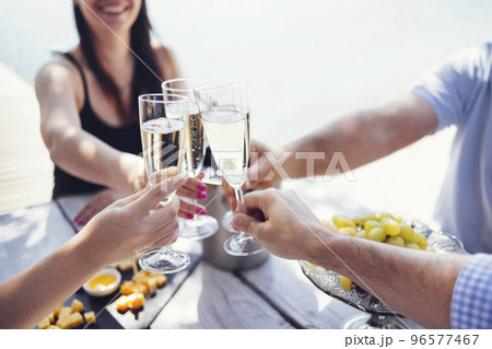 Happy people on the beach having a party, drinking and having a lot of fun in the sunse Happy people on the beach having a party, drinking and having a lot of fun in the sunse 96577467