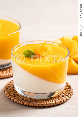 Delicious double colored mango panna cotta mousse pudding on wooden table background. 96578460