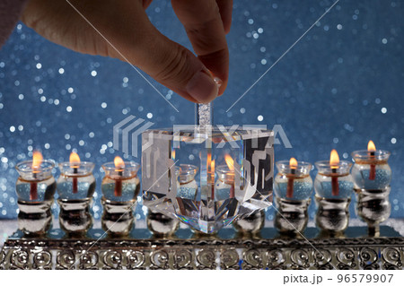Jewish holiday Hanukkah background with oil menorah and dreidel with letters Gimel and Nun. 96579907