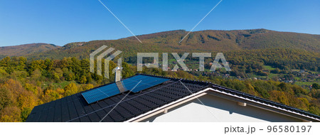 High angle view of solar photovoltaic panels on roof, alternative energy, saving resources and sustainable lifestyle concept. High angle view of solar photovoltaic panels on roof, alternative energy, saving resources and sustainable lifestyle concept. 96580197