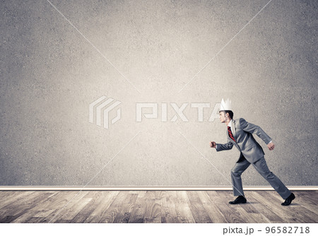 King businessman in elegant suit running in empty room King businessman in elegant suit running in empty room 96582718