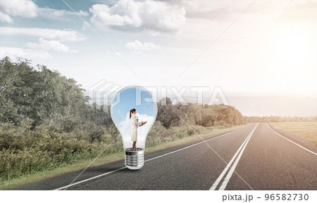 Businesswoman inside light bulb 96582730