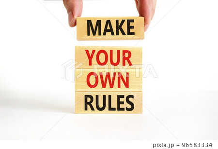 Make your own rules symbol. Concept words Make your own rules on wooden cubes. Beautiful white table white background. Businessman hand. Business motivational make your own rules concept. Copy space 96583334