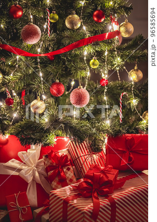 Christmas gifts and festive holiday presents, classic xmas gift boxes under decorated christmas tree, happy holidays and boxing day celebration theme 96585694