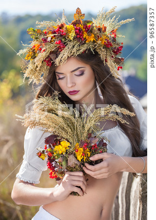Ukrainian girl with colorful wreath on his head and a bouquet of wild flowers in the style of ethnic, boho, Provence, vintage, shabby chic Ukrainian girl with colorful wreath on his head and a bouquet of wild flowers in the style of ethnic, boho, Provence, vintage, shabby chic 96587357