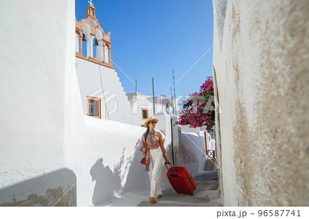 Young woman travels around the island of Santorini 96587741