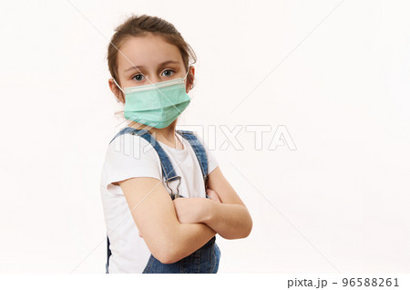 Adorable little girl in protective mask, isolated on white. Virus symptoms. Concept of air pollution, epidemic, influenza, protection from disease. Flu illness. Pediatrics. Medical care. Insurance. Adorable little girl in protective mask, isolated on white. Virus symptoms. Concept of air pollution, epidemic, influenza, protection from disease. Flu illness. Pediatrics. Medical care. Insurance. 96588261