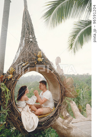 couple relaxing at an amazing beach club in Bali indonesia 96591204