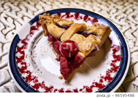 A slice of delicious cherry pie on a plate food illustration 96595486