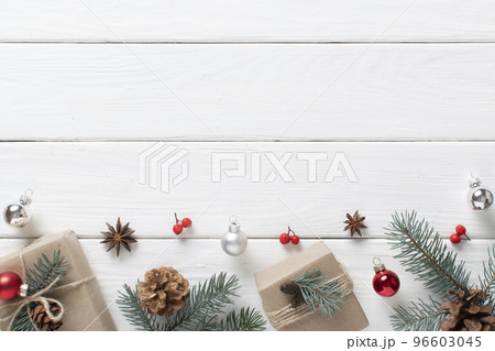 Christmas gifts wrapped in kraft paper and decorated with natural materials on a white wooden table. Christmas zero Christmas gifts wrapped in kraft paper and decorated with natural materials on a white wooden table. Christmas zero 96603045