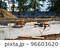Electric tool on the concrete foundation of a huge fenced construction site in the city center 96603620