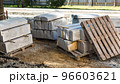 Concrete blocks and a wooden pallet on a fenced construction site in the city center 96603621
