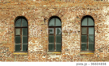 Windows of a brick tower in the Gothic style 96604898