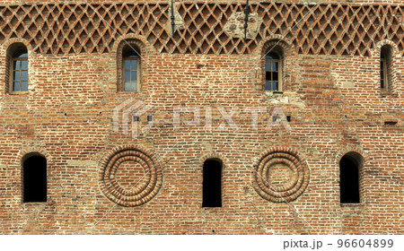 Windows of a brick tower in the Gothic style 96604899