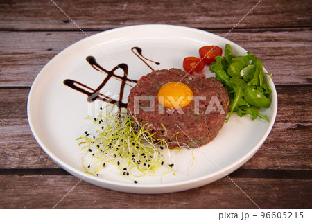 Steak Tartare with vegetables salad and french fries on dish Steak Tartare with vegetables salad and french fries on dish 96605215