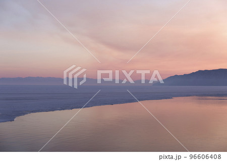 Beautiful sunset on frozen lake Baikal. Winter landscape. Beautiful sunset on frozen lake Baikal. Winter landscape. 96606408