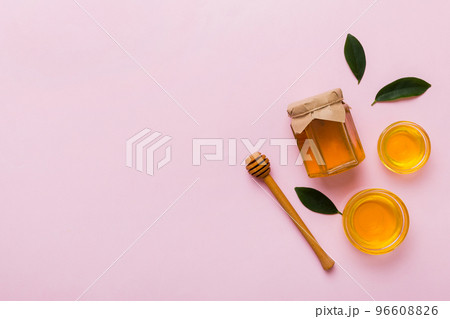 Honey jar with wooden honey dipper on white background top view with copy space. Delicious honey bottle 96608826