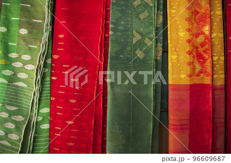 Bangladeshi Women,s Traditional Colorful Jamdani saree hanging in the retail Showrooms. Colorful Jamdani Saree Texture Background Bangladeshi Women,s Traditional Colorful Jamdani saree hanging in the retail Showrooms. Colorful Jamdani Saree Texture Background 96609687