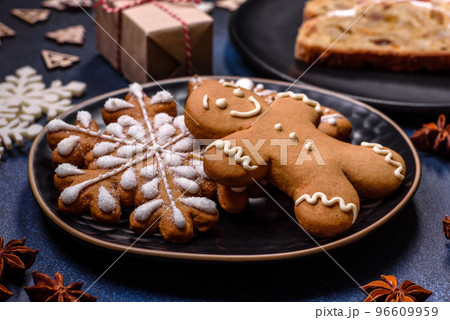 Delicious festive New Year's pie with candied fruits, marzipan and nuts on a dark concrete background 96609959