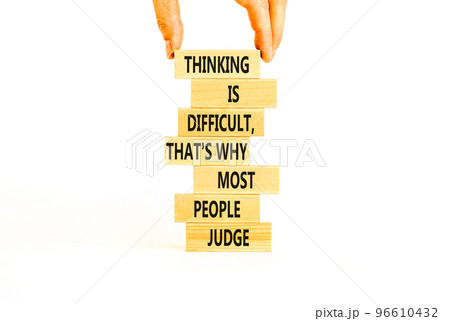 Thinking or judge symbol. Concept words Thinking is difficult that is why most people judge on blocks. Psychologist hand. Beautiful white background. Business thinking or judge concept. Copy space. 96610432