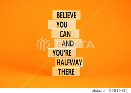 You can symbol. Concept words Believe you can and you are halfway there on wooden blocks on a beautiful orange table orange background. Business motivational and you can concept. 96610433