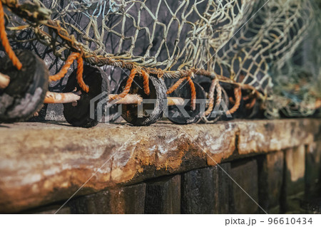 Old fishing net on a rotten wooden pier 96610434