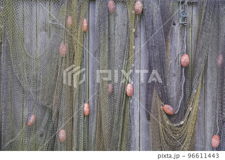 Old fishing net on a wooden fence. Background 96611443