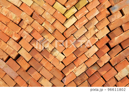Construction Materials. Pile of red bricks at construction site. Building stone for construction of buildings and structures, pattern. Close up. Construction Materials. Pile of red bricks at construction site. Building stone for construction of buildings and structures, pattern. Close up. 96611802