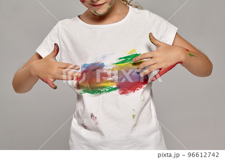 Beautiful little girl with a painted fingers is posing on a gray background. Beautiful little girl with a painted fingers is posing on a gray background. 96612742