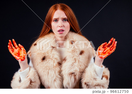 sad redhaired ginger fashion victim woman with blood on her hands wearing natural fur coat and crying,studio black background.stop animal killing please sad redhaired ginger fashion victim woman with blood on her hands wearing natural fur coat and crying,studio black background.stop animal killing please 96612750
