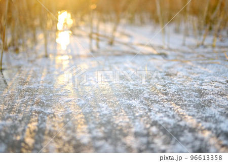 Ice surface of a frozen lake or river on a cold sunny winter sunset. Seasonal specific. 96613358